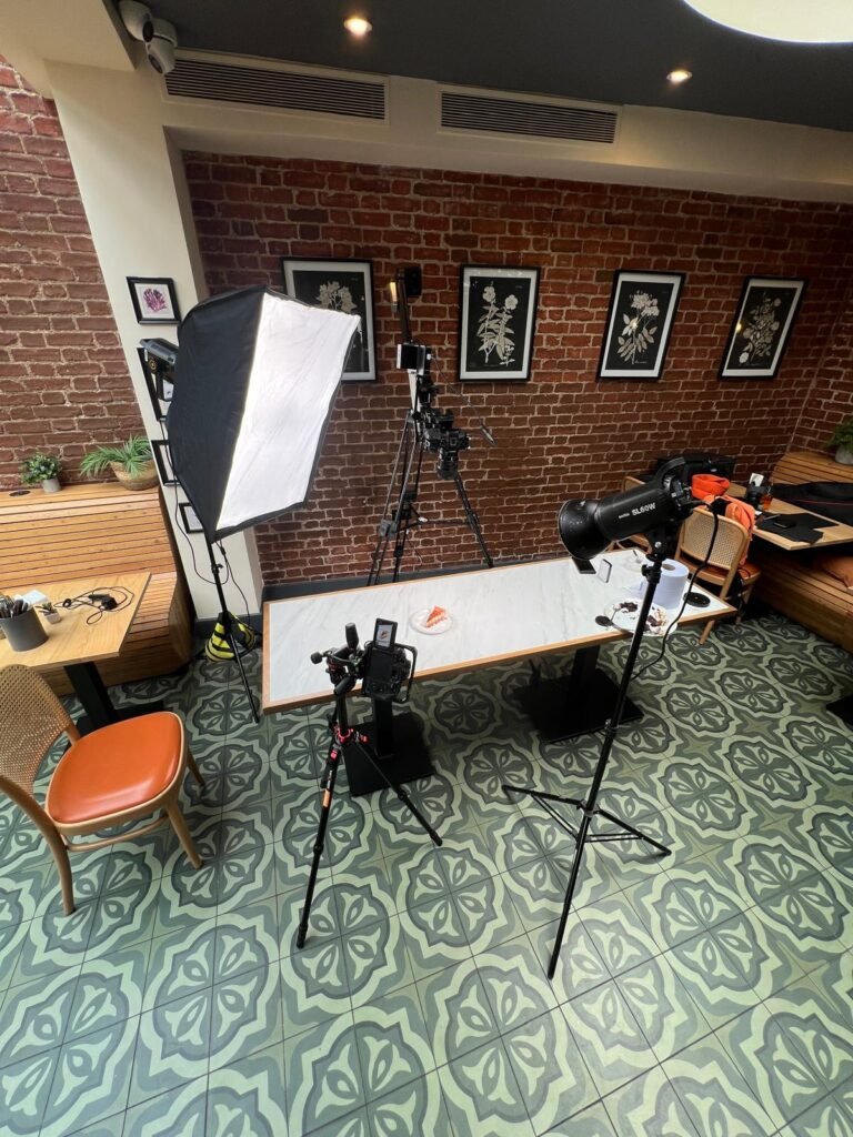 Mobile studio set up inside a working dining room with softbox, overhead boom and marble table