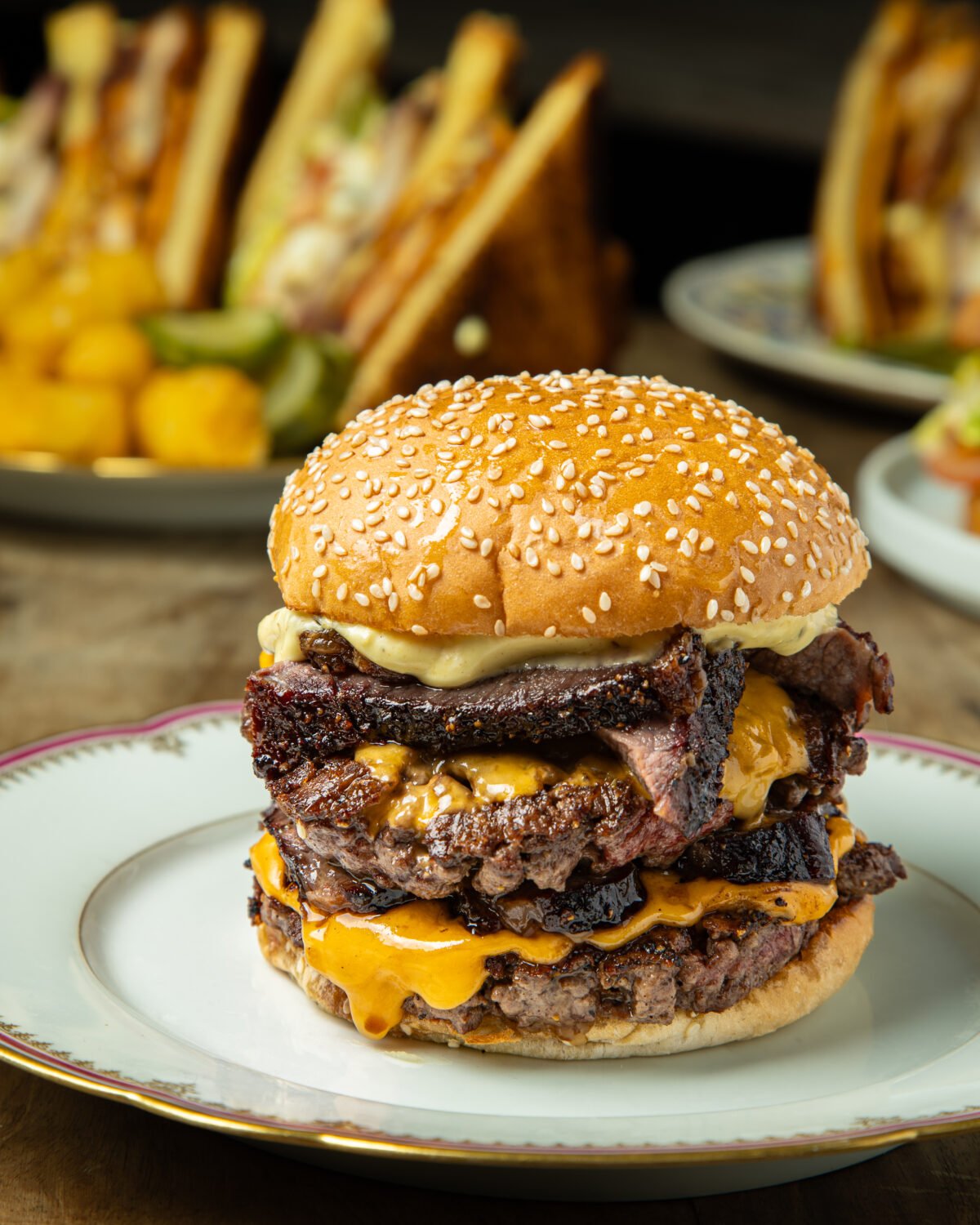 Barbecue burger plated on china in the restaurant with the rest of the table behind