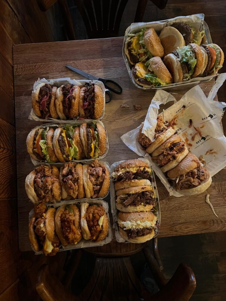 Most of a barbecue menu laid out in trays on one table, ready to be photographed