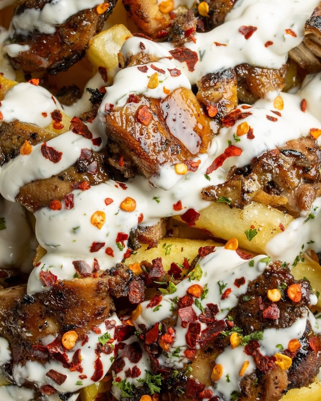 Loaded fries topped with beef burnt ends, garlic sauce and chilli flakes