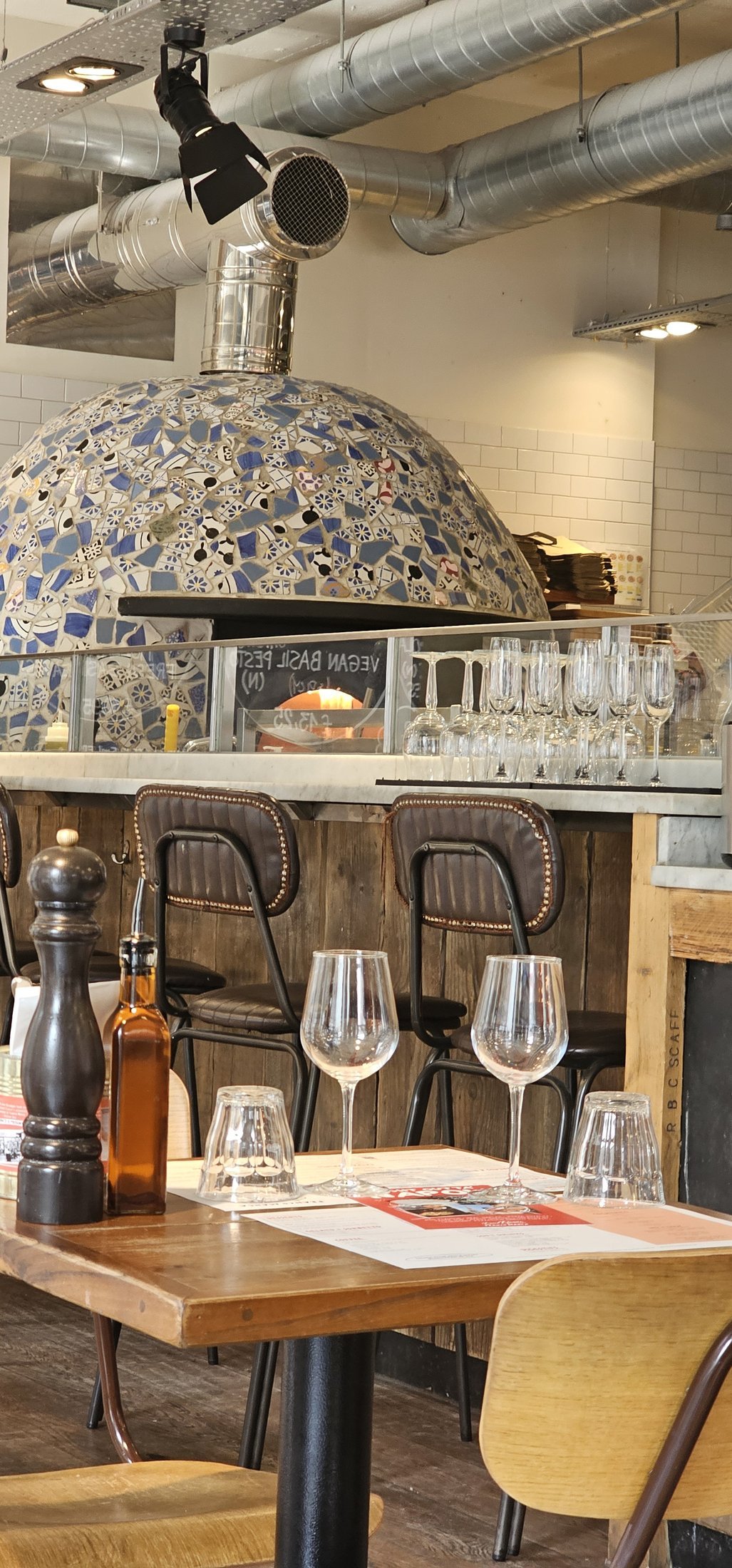 The mosaic-domed pizza oven and dining room at Franco Manca on Baker Street, dressed and empty, a location for a restaurant group film shoot in London.
