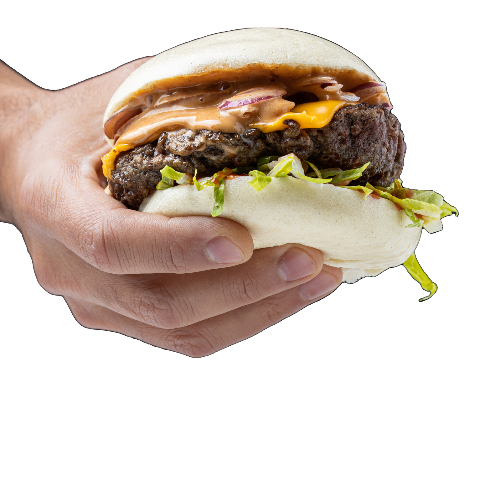 A hand holding a bao cheeseburger on a transparent background, cut-out lifestyle product photography for a food manufacturer's advertising.