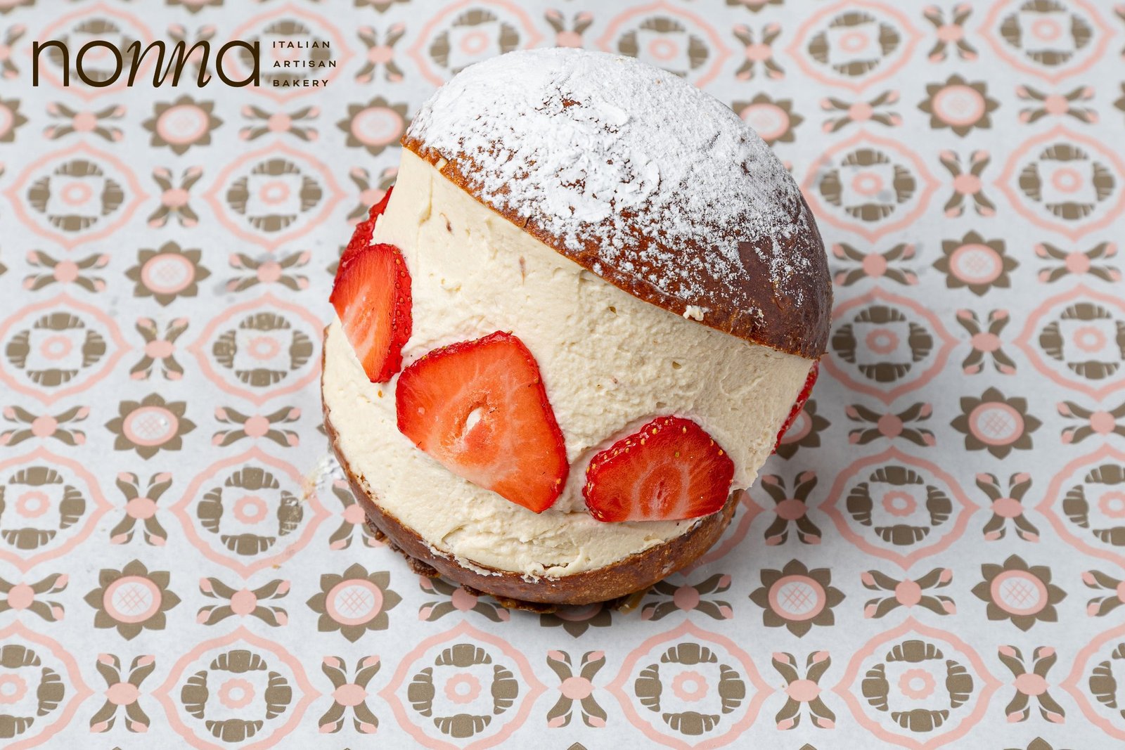 Strawberry maritozzo, a split brioche filled with cream with strawberry slices set into it and dusted with icing sugar, bakery photography for a Sicilian bakery in Holborn, London.